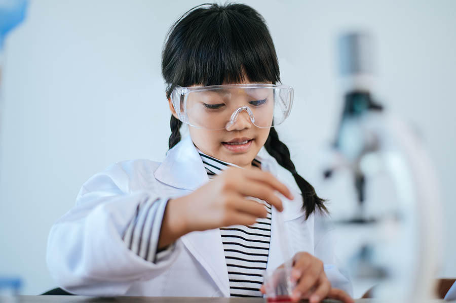 Girl doing science experiments in school